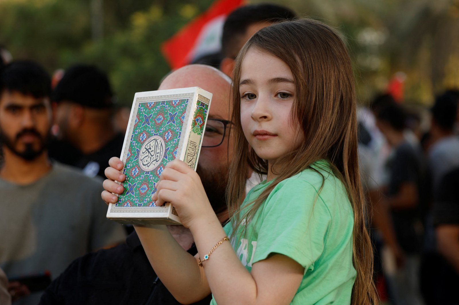 A child holds the Quran during a protest near Baghdad, Iraq, July 22, 2023. (Reuters Photo)