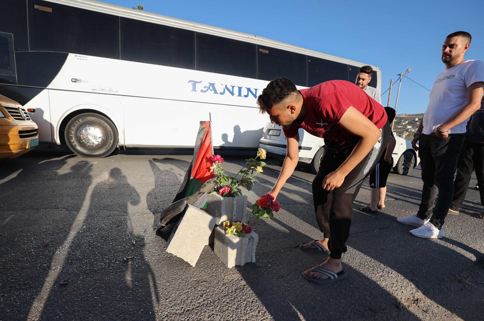 Mourners lay roses at the site where three Palestinians were killed by Israeli forces, Jenin, occupied West Bank, Palestine, Aug. 6, 2023. (AFP Photo)